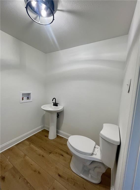 144 Yvonne Dr, Avondale, LA 70094 - bathroom with toilet and wood finished floors