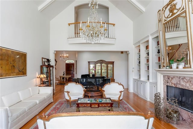 15 Muirfield Pl, New Orleans, LA 70131 - living room featuring a chandelier, high vaulted ceiling, wood finished floors, and a high end fireplace