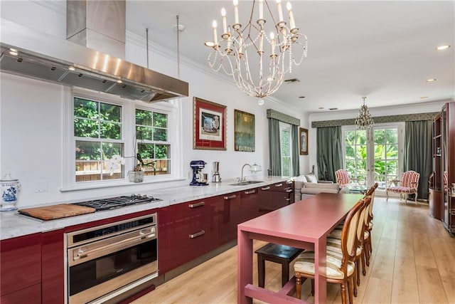 15 Muirfield Pl, New Orleans, LA 70131 - kitchen with stainless steel appliances, exhaust hood, crown molding, modern cabinets, and a chandelier