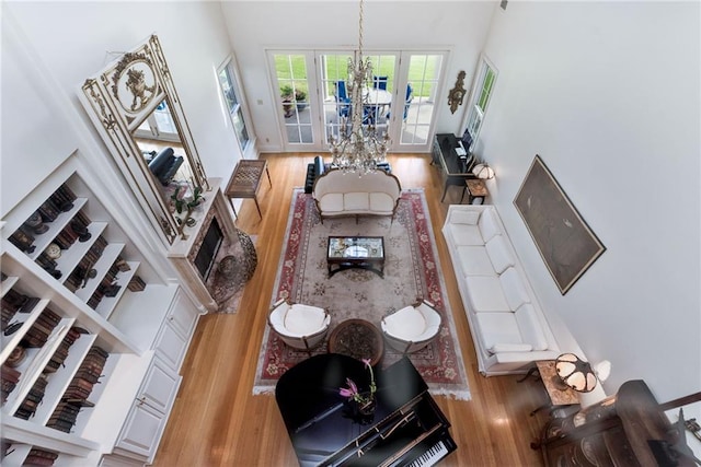 15 Muirfield Pl, New Orleans, LA 70131 - living area featuring wood finished floors, a chandelier, and a towering ceiling