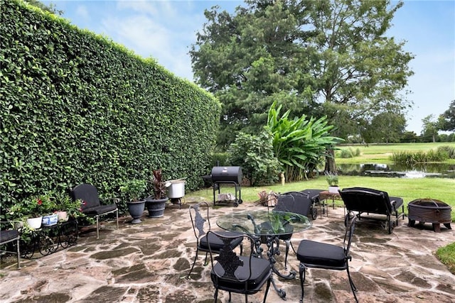 15 Muirfield Pl, New Orleans, LA 70131 - view of patio featuring a fire pit, a grill, and a water view