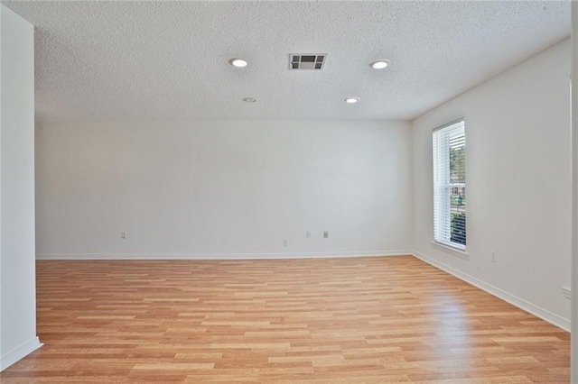 4152 Cognac Dr, Kenner, LA 70065 - spare room featuring light wood-type flooring, a textured ceiling, and recessed lighting