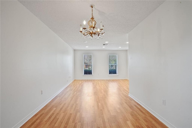 4152 Cognac Dr, Kenner, LA 70065 - unfurnished living room with a textured ceiling, a chandelier, light wood-style flooring, and recessed lighting