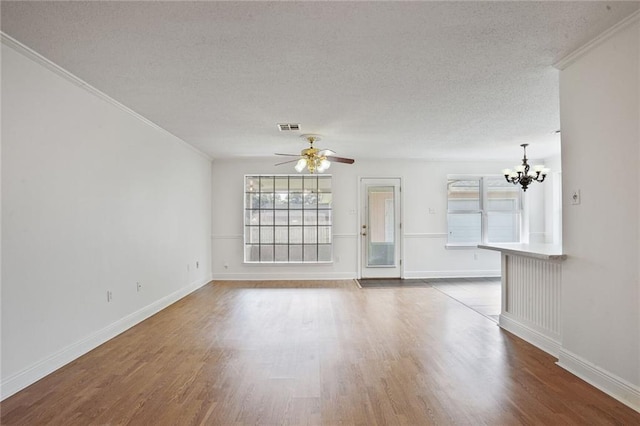4152 Cognac Dr, Kenner, LA 70065 - unfurnished living room with a chandelier, a textured ceiling, wood finished floors, crown molding, and ceiling fan