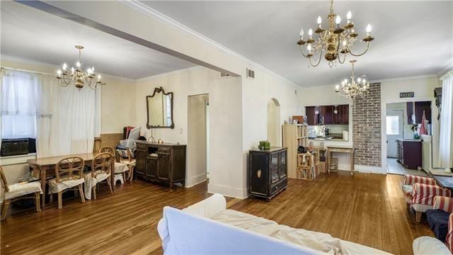 4429-31 Eden Ln, New Orleans, LA 70125 - living area featuring a chandelier, wood finished floors, arched walkways, and crown molding