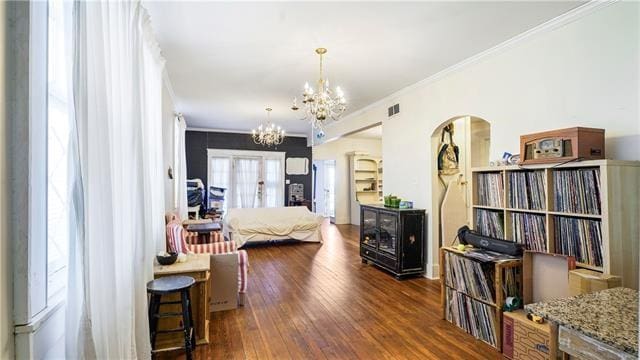 4429-31 Eden Ln, New Orleans, LA 70125 - bedroom with arched walkways, a chandelier, hardwood / wood-style flooring, and ornamental molding
