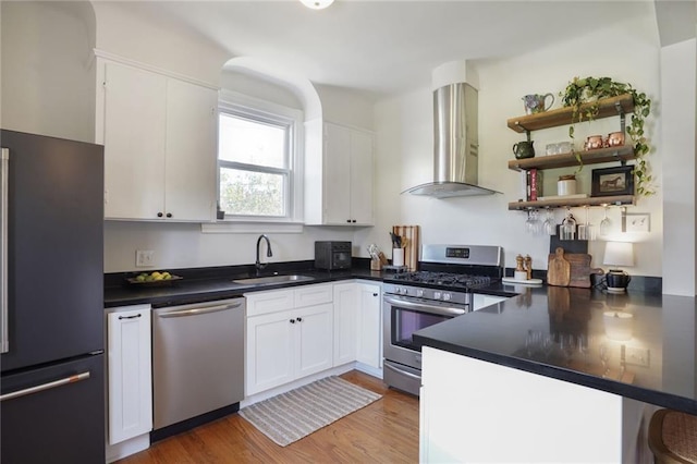 4717 Orleans Blvd, Jefferson, LA 70121 - kitchen featuring stainless steel appliances, wall chimney exhaust hood, and white cabinetry