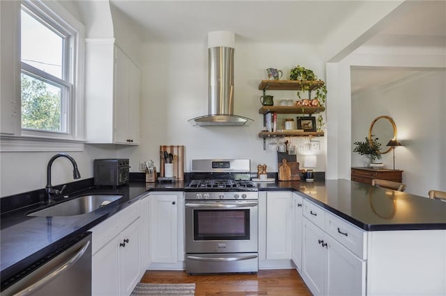 4717 Orleans Blvd, Jefferson, LA 70121 - kitchen with appliances with stainless steel finishes, wall chimney range hood, a peninsula, and white cabinets