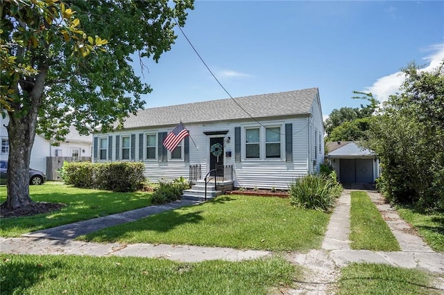 4717 Orleans Blvd, Jefferson, LA 70121 - view of front of house featuring a front lawn and roof with shingles