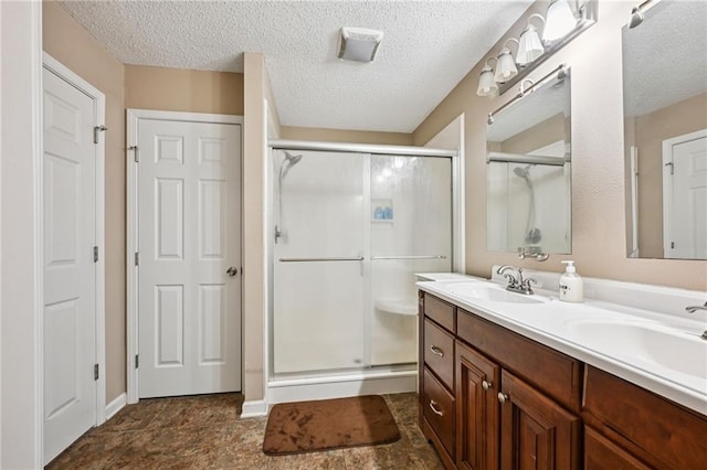 1702 Barrymore St, Slidell, LA 70461 - full bath featuring a shower stall, double vanity, and a textured ceiling