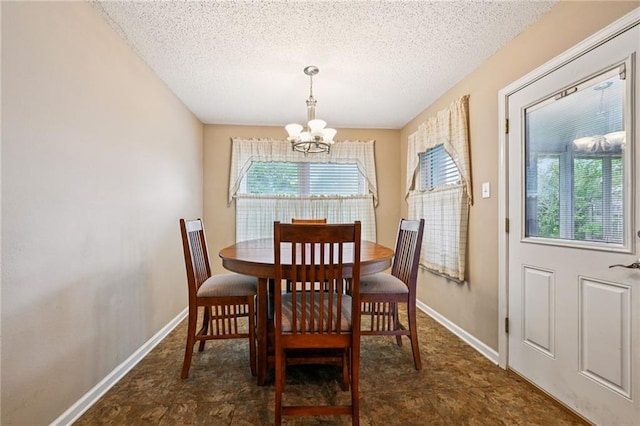 1702 Barrymore St, Slidell, LA 70461 - dining area with a chandelier, plenty of natural light, and a textured ceiling
