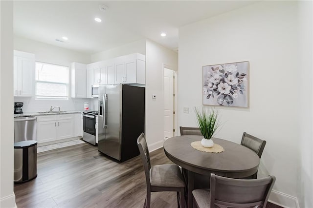 8532 Regiment Dr, Chalmette, LA 70043 - dining room featuring wood finished floors and recessed lighting
