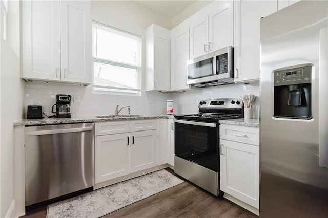 8532 Regiment Dr, Chalmette, LA 70043 - kitchen featuring stainless steel appliances, tasteful backsplash, white cabinetry, and dark wood finished floors