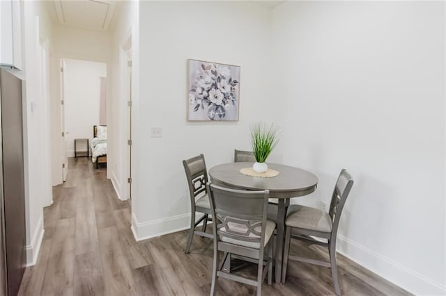 8532 Regiment Dr, Chalmette, LA 70043 - dining space featuring attic access and light wood-style floors