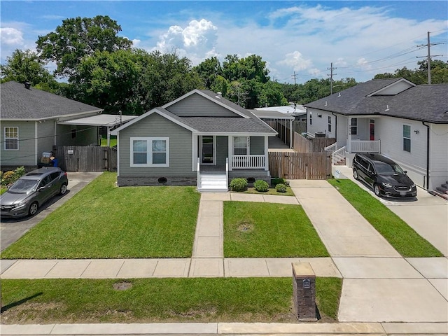 4850 Pauline Dr, New Orleans, LA 70126 - bungalow-style house featuring covered porch, a gate, and driveway