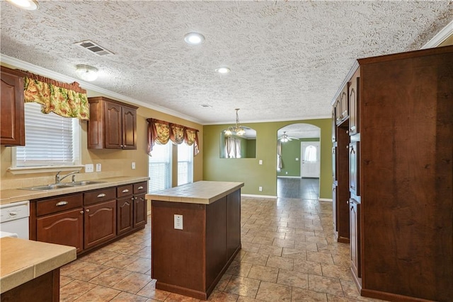 4850 Pauline Dr, New Orleans, LA 70126 - kitchen with dishwasher, ornamental molding, a center island, decorative light fixtures, and light stone finish flooring