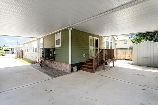 4850 Pauline Dr, New Orleans, LA 70126 - view of patio featuring a shed and a carport