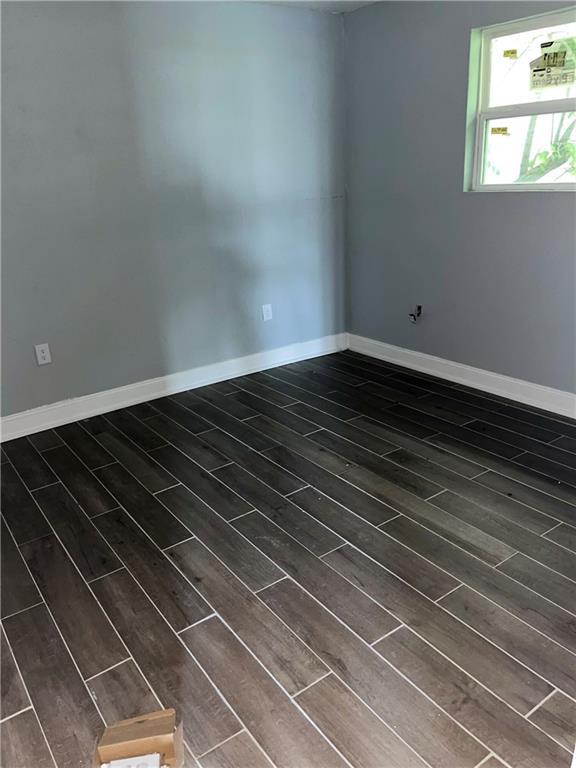184143 Gordon St, New Orleans, LA 70117 - unfurnished room with wood finish floors and baseboards