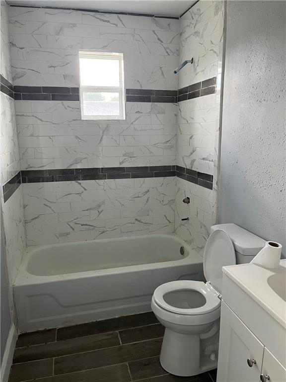 184143 Gordon St, New Orleans, LA 70117 - bathroom featuring vanity, shower / washtub combination, and wood tiled floors