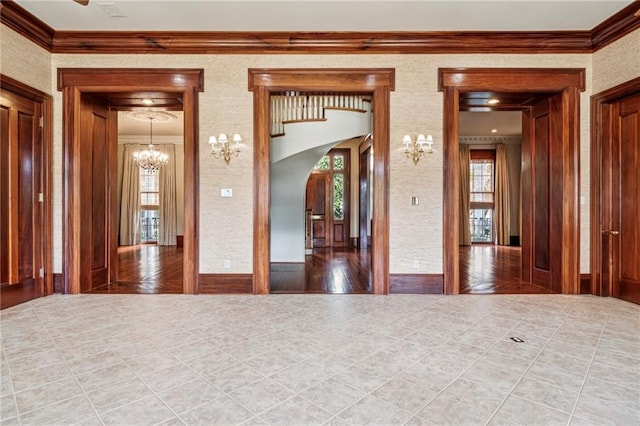 52 Tokalon Pl, Metairie, LA 70001 - tiled spare room with a chandelier, arched walkways, and crown molding