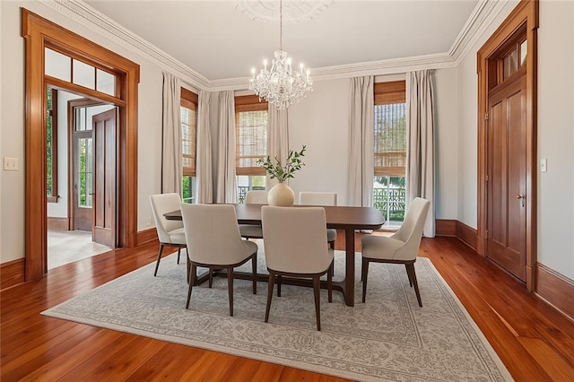 52 Tokalon Pl, Metairie, LA 70001 - dining area with a chandelier, wood-type flooring, and crown molding