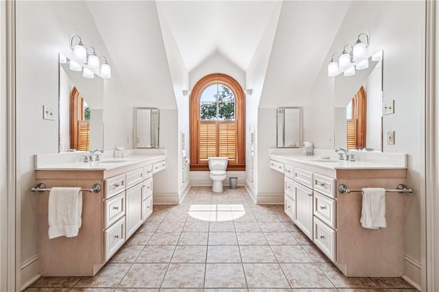 52 Tokalon Pl, Metairie, LA 70001 - bathroom with two vanities, vaulted ceiling, and tile patterned floors
