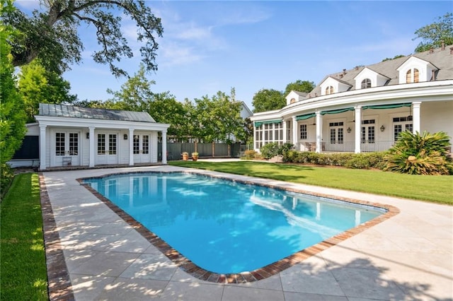 52 Tokalon Pl, Metairie, LA 70001 - swimming pool with french doors, an exterior structure, a patio area, and an outbuilding
