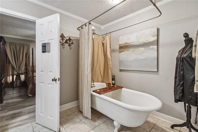 4969 Tasha Ln, Jean Lafitte, LA 70067 - full bathroom with a freestanding bath, a textured ceiling, ornamental molding, tile patterned flooring, and a shower with curtain
