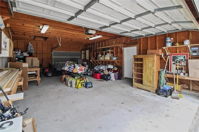 4969 Tasha Ln, Jean Lafitte, LA 70067 - garage with a workshop area and a garage door opener