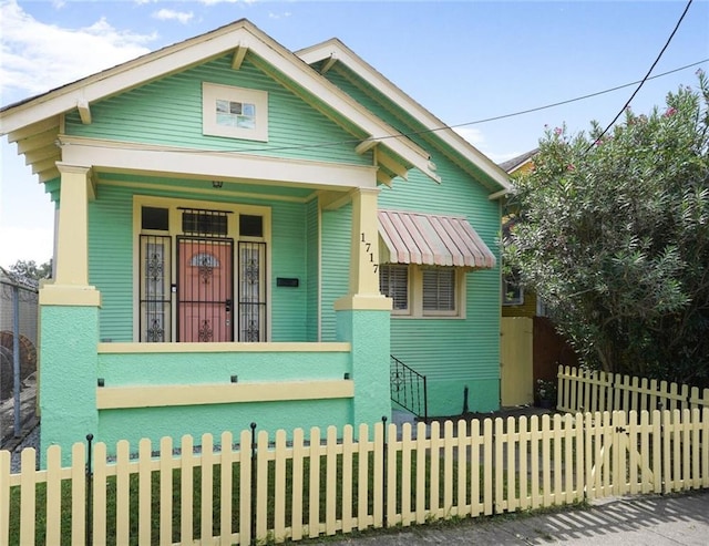1717 Painters St, New Orleans, LA 70117 - view of front of house with covered porch and a fenced front yard