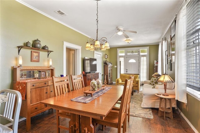 1717 Painters St, New Orleans, LA 70117 - dining area with hardwood / wood-style flooring, crown molding, ceiling fan, and a chandelier