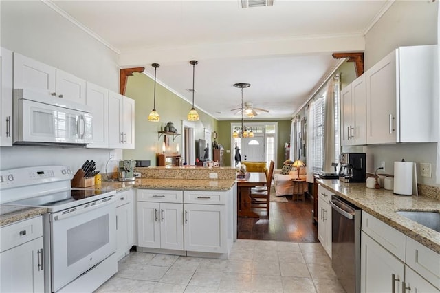 1717 Painters St, New Orleans, LA 70117 - kitchen featuring white appliances, crown molding, a peninsula, decorative light fixtures, and white cabinetry