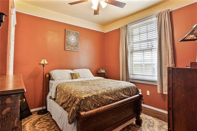 1717 Painters St, New Orleans, LA 70117 - bedroom with multiple windows, wood finished floors, and a ceiling fan