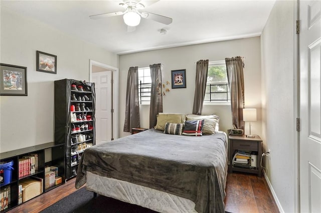 1717 Painters St, New Orleans, LA 70117 - bedroom featuring dark wood-type flooring, multiple windows, and ceiling fan
