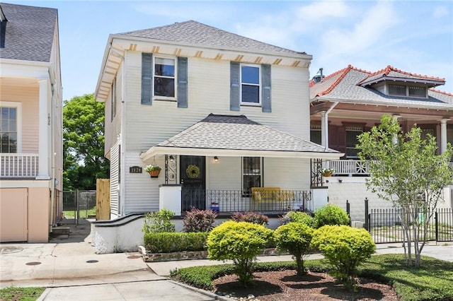 1824 Ursulines Ave, New Orleans, LA 70116 - view of front facade with covered porch and a shingled roof