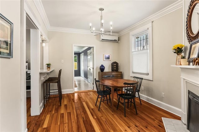 1824 Ursulines Ave, New Orleans, LA 70116 - dining area with a wall mounted AC, a chandelier, hardwood / wood-style floors, crown molding, and healthy amount of natural light