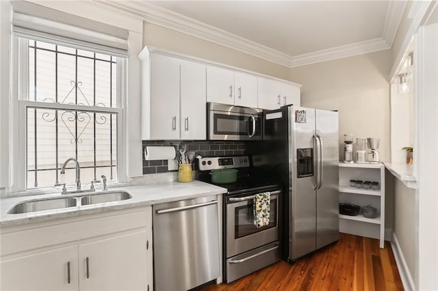 1824 Ursulines Ave, New Orleans, LA 70116 - kitchen with appliances with stainless steel finishes, ornamental molding, white cabinets, dark wood-type flooring, and decorative backsplash