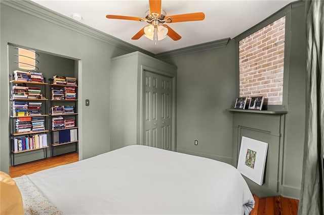 1824 Ursulines Ave, New Orleans, LA 70116 - bedroom featuring crown molding, wood finished floors, a closet, and a ceiling fan
