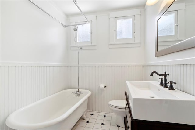 1419 Pine St, New Orleans, LA 70118 - bathroom with a freestanding bath, wainscoting, vanity, tile patterned flooring, and a shower