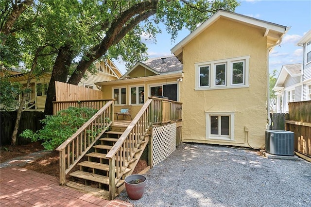 1419 Pine St, New Orleans, LA 70118 - rear view of property featuring stucco siding, a deck, a patio area, and stairs
