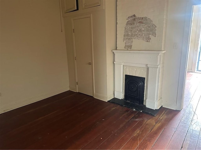 5827 Tchoupitoulas St, New Orleans, LA 70115 - unfurnished living room with dark wood finished floors and a fireplace