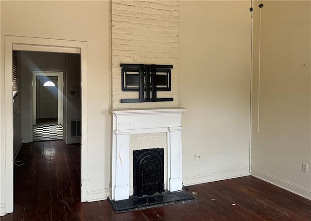 5827 Tchoupitoulas St, New Orleans, LA 70115 - unfurnished living room featuring hardwood / wood-style floors and a fireplace with raised hearth