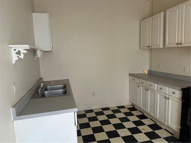 5827 Tchoupitoulas St, New Orleans, LA 70115 - kitchen featuring light floors, white cabinetry, range, and light countertops