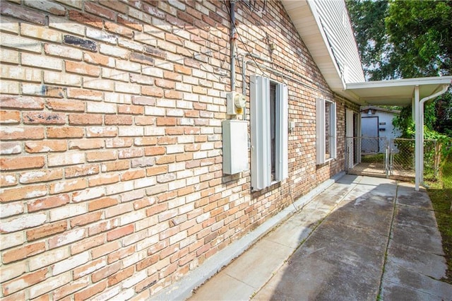 8013 Simon St, Metairie, LA 70003 - view of property exterior with brick siding and a gate
