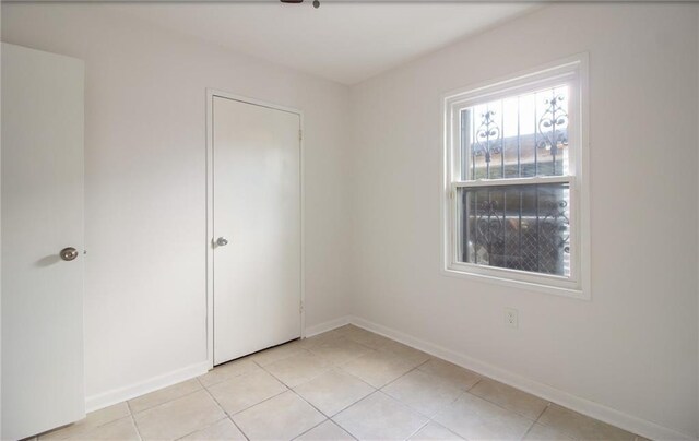 8013 Simon St, Metairie, LA 70003 - unfurnished bedroom with light tile patterned flooring