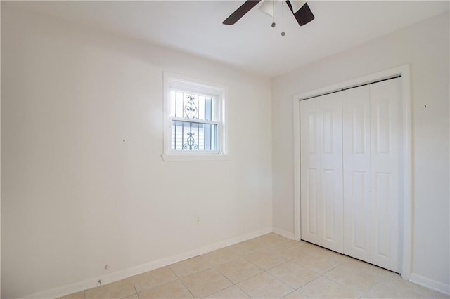 8013 Simon St, Metairie, LA 70003 - unfurnished bedroom featuring light tile patterned floors, a closet, and ceiling fan