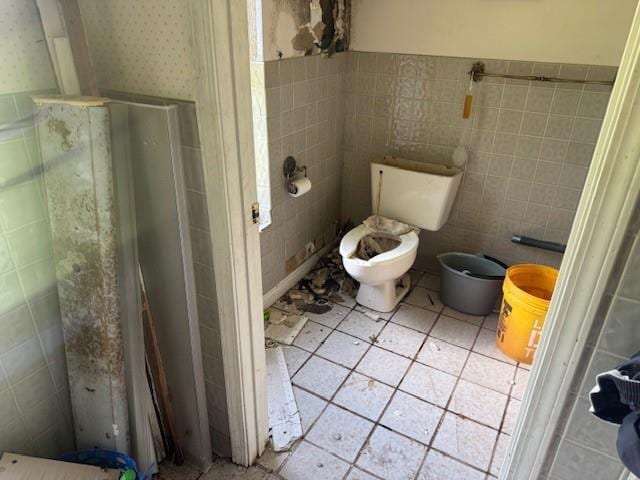 85274 Kings Rd, Bogalusa, LA 70427 - bathroom featuring a shower stall, tile patterned floors, tile walls, and a wainscoted wall