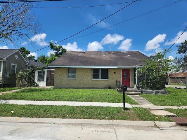 4440 Werner Dr, New Orleans, LA 70126 - view of front of house featuring brick siding, a front yard, and roof with shingles