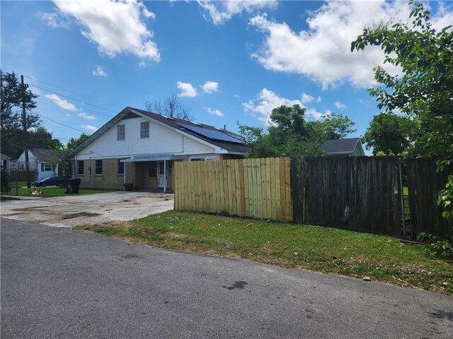 4440 Werner Dr, New Orleans, LA 70126 - view of front of house with solar panels and concrete driveway