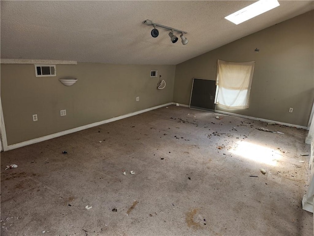 4440 Werner Dr, New Orleans, LA 70126 - unfurnished room with a textured ceiling, vaulted ceiling, and rail lighting